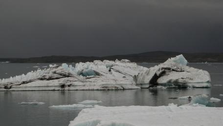 Majestic Icebergs Under Dark Clouds wallpaper