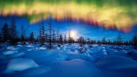 Dancing Lights Over Winter Landscape wallpaper