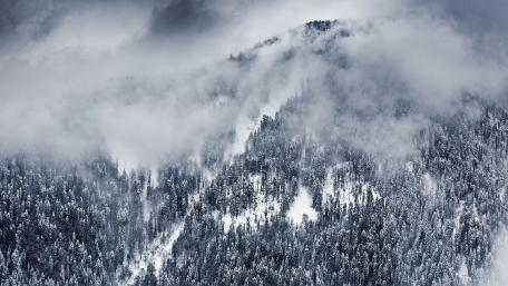 Majestic Snowy Landscape with Foggy Mountains wallpaper