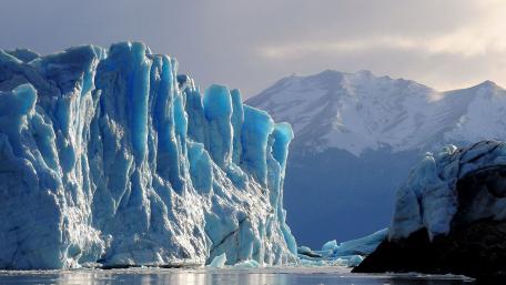Majestic Icebergs Beneath a Cloudy Sky wallpaper