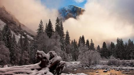 Majestic Winter Landscape Embraced by Misty Mountains wallpaper