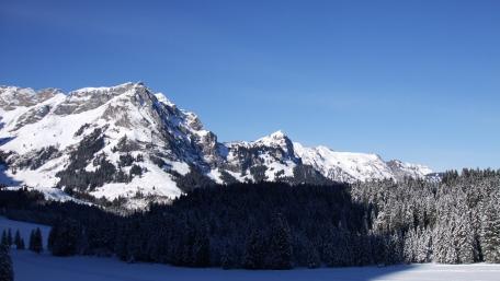 Majestic Snow-Capped Mountains Under Clear Blue Sky wallpaper