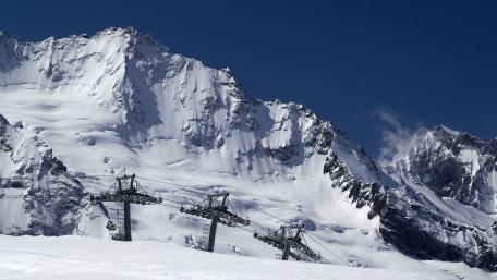 Majestic Snowy Peaks Under Clear Blue Sky wallpaper