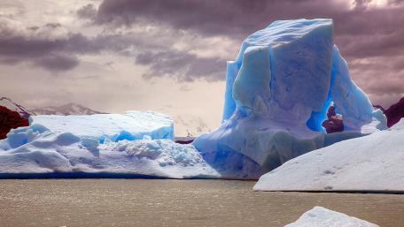 Majestic Iceberg Amidst Dramatic Skies wallpaper