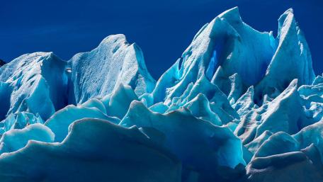 Majestic Ice Formations Under Clear Blue Sky wallpaper