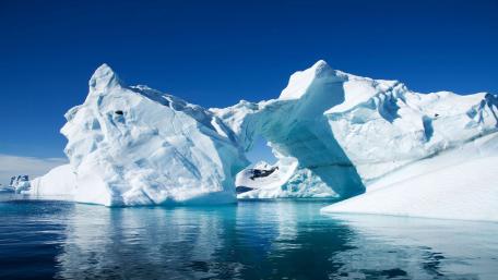 Majestic Ice Arch Under Clear Blue Sky wallpaper