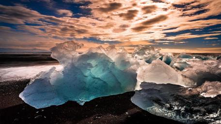 Crystal Blue Icebergs Against a Dramatic Sky wallpaper