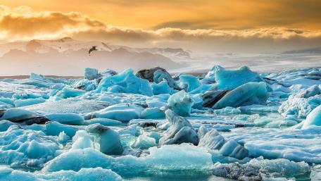 Majestic Ice Formations Under a Golden Sky wallpaper