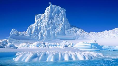 Majestic Iceberg Beneath a Clear Sky wallpaper