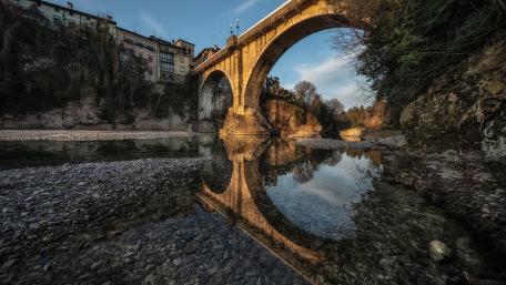 Tranquil River Reflection Under the Historic Bridge wallpaper