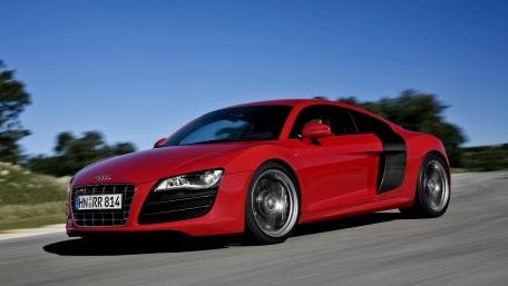 Sleek Red Sports Car in Motion wallpaper