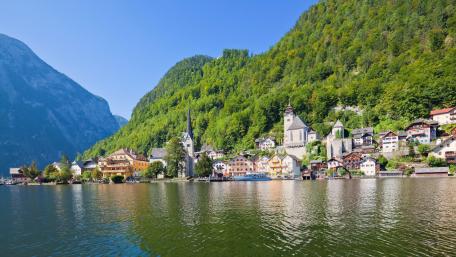 Charming Lakeside Village Surrounded by Mountains wallpaper