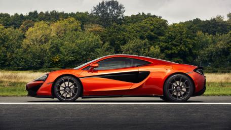 Sleek Orange Supercar on the Road wallpaper