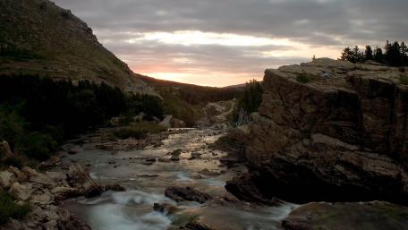 Serene River at Dusk in a Mountain Landscape wallpaper