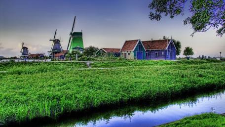 Charming Village with Windmills and Lush Greenery wallpaper