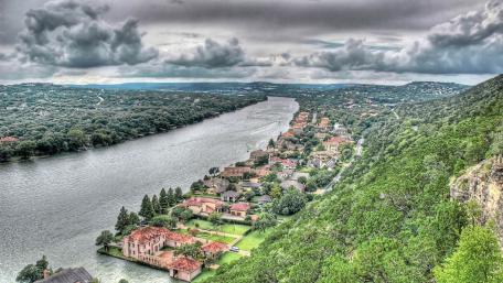 Serene River View Amidst Urban Living wallpaper