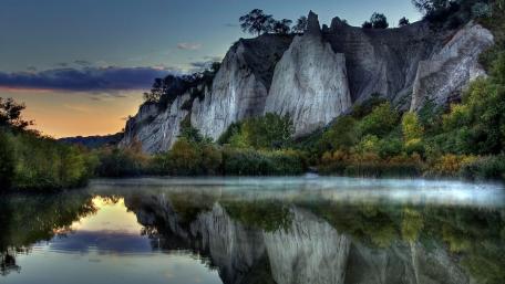 Majestic Cliffs Reflecting in Serene Waters wallpaper