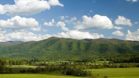 Serene Mountain Landscape Under a Blue Sky wallpaper