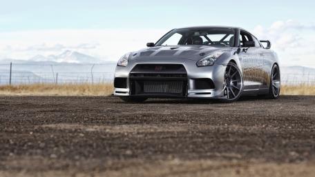 Sleek Silver Sports Car on Open Road wallpaper