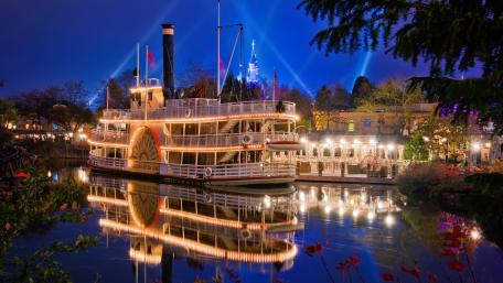 Captivating Night Views of a Riverboat City Scene wallpaper