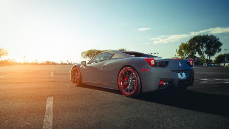 Sleek Ferrari Under a Sunset Sky wallpaper