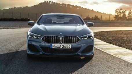 Sleek BMW Coupe on Racing Track at Sunset wallpaper