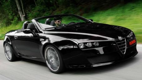 Sleek Black Convertible on a Scenic Drive wallpaper