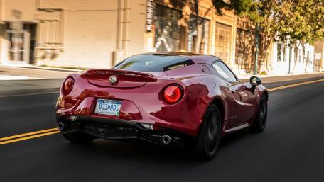 Sleek Red Sports Car in Motion 4K Wallpaper wallpaper