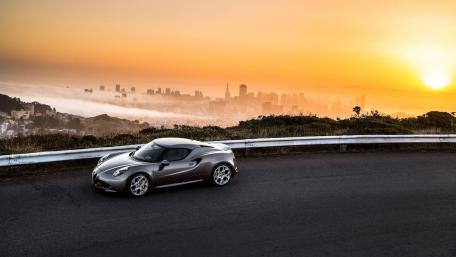 Stunning Sunset with a Sleek Sports Car wallpaper