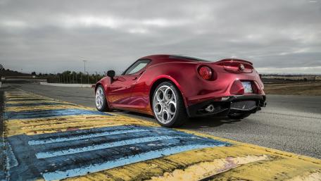 Sleek Red Sports Car on an Open Track wallpaper