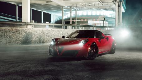 Sleek Red Sports Car in Urban Night Setting wallpaper