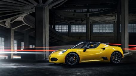 Sleek Yellow Sports Car in Urban Setting wallpaper