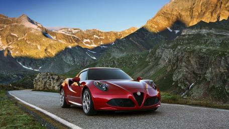 Stunning Red Sports Car in Majestic Mountains wallpaper