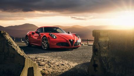 Striking Alfa Romeo in Scenic Sunset Setting wallpaper