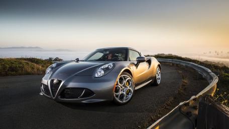 Sleek Silver Sports Car on a Scenic Roadway wallpaper