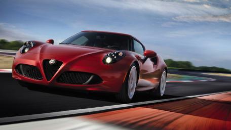 Dynamic Red Sports Car Racing on Track wallpaper