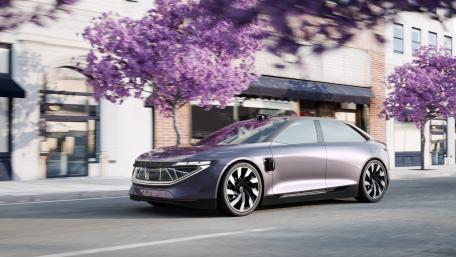 Sleek Electric Car in a Blooming Urban Setting wallpaper