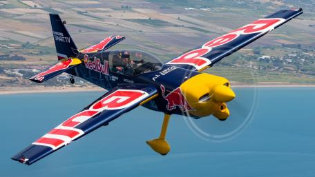 Experience the Thrill of Aerobatics in a Red Bull Plane wallpaper