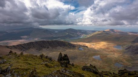 Breathtaking Mountain Landscape Under Dramatic Skies wallpaper