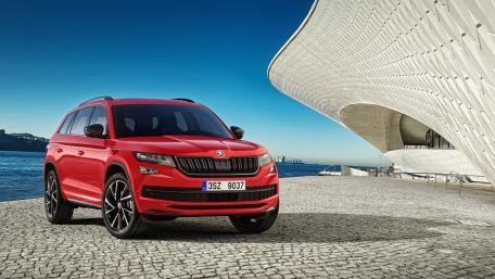 Sleek Red SUV by the Waterfront wallpaper