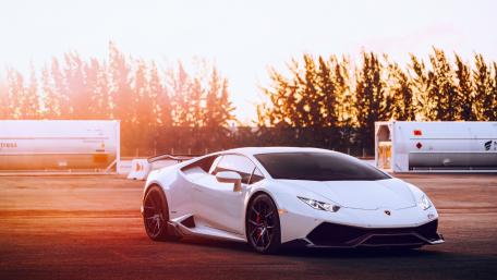 Sleek White Sports Car Under Sunset Glow wallpaper