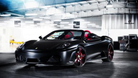Sleek Black Ferrari in a Modern Garage wallpaper