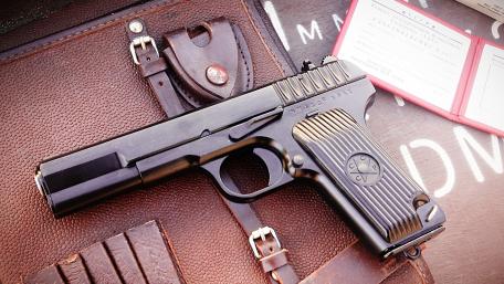 Classic Military Handgun Displayed with Leather Case wallpaper