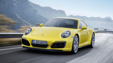 Sleek Yellow Porsche on Scenic Mountain Road wallpaper