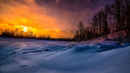 Winter Sunset Over Snowy Landscape wallpaper