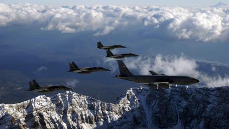 Aerial Precision Over Majestic Mountains Travelled by Military Aircrafts wallpaper