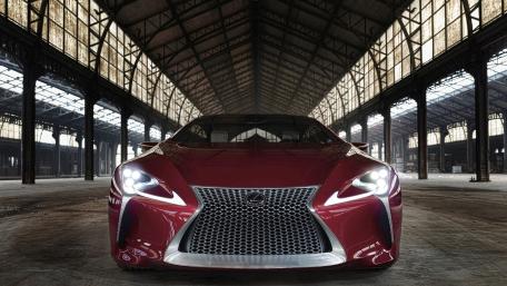 Sleek Red Luxury Car in Abandoned Warehouse wallpaper