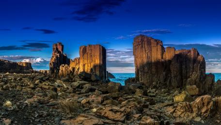 Majestic Coastal Rock Formations Under Twilight Sky wallpaper