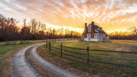 Serene Sunset Over a Rustic Homestead wallpaper