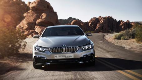Sleek Silver BMW on Scenic Roadway in Nature wallpaper